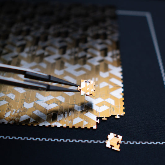 Close-up of 16 Squared titanium jigsaw puzzle pieces showing interlocking square tabs